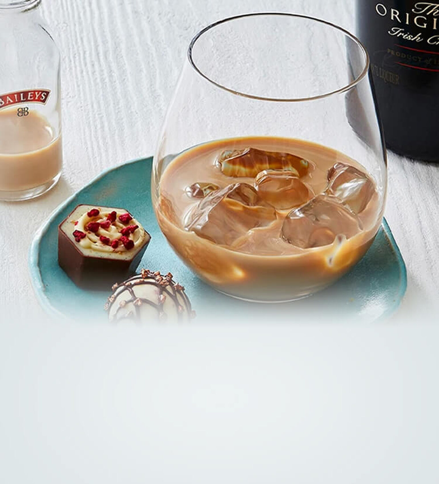 Image of a Cognac Old Fashioned on a mirrored surface